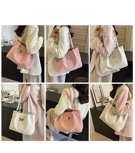Detailed views of the butterfly tote bag in pink and beige faux leather on a model