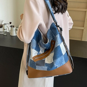Patchwork denim tote bag with leather bottom shown in a stylish cafe setting