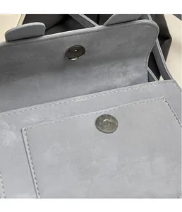 Detail view of the secure metal magnetic closure and premium stitching on a grey bag