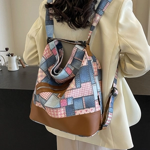 Vintage patchwork canvas backpack with denim and floral patterns and brown leather accents