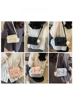 Models showcasing four colors of mini crossbody satchels with plush charms and straps