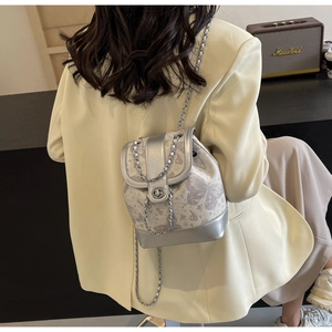 Detail of silver butterfly jacquard mini backpack with metal chain and magnetic buckle