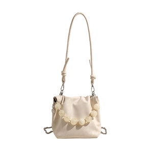 Elegant cream pleated crossbody bucket bag with beaded chain and soft leather texture