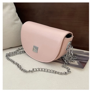 Detail view of pink mini saddle bag with silver metal buckle and elegant chain strap