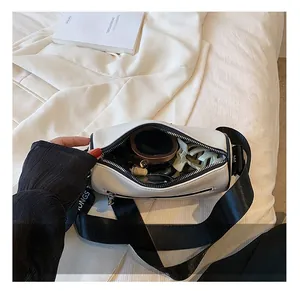 Internal view of the white cylinder bag showing space for lipstick and cosmetics