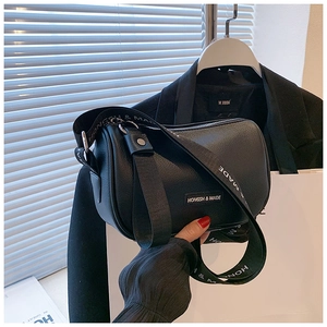 Detail of black cylindrical Boston bag with litchi texture and printed wide strap