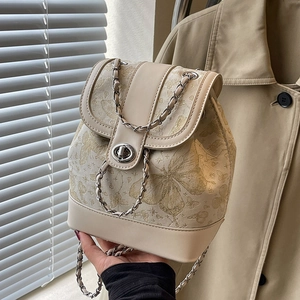 Chic beige mini backpack featuring gold butterfly jacquard with silver chain details