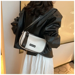 Detail of contrast bow shoulder bag with textured leather and branded logo strap
