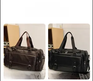 Detail view of large travel duffel bags in coffee and black with vintage leather texture