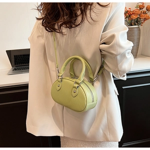 Dettaglio della borsa a mano plissettata verde chiaro con tracolla in stile moderno