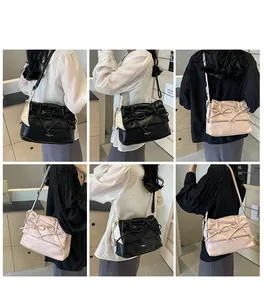 Detailed views of stylish bow shoulder bags in black and pink with silk scarf accents