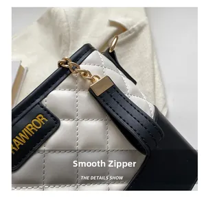 Detailed close-up of the smooth golden zipper and quilted leather on this stylish bucket bag