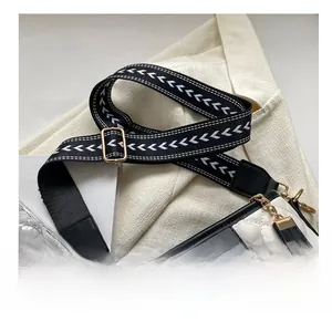 Detail of adjustable woven strap with V-pattern on white quilted hobo shoulder bag