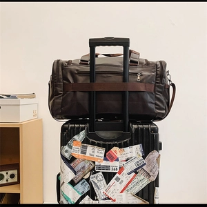 Travel bag featuring luggage handle sleeve for easy attachment to suitcases