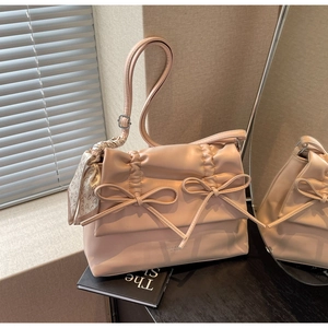 Detail of light pink PU leather tote bag with double bows and heart printed silk scarf