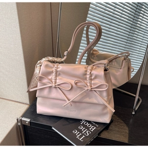 Detail of light pink tote bag with bow knots, heart print scarf, and fashion text