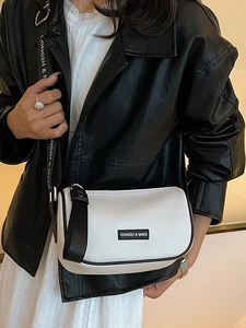 Minimalist black and white contrast bow crossbody bag with textured leather and wide strap