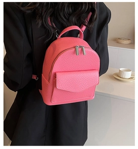 Detailed macro view of pink litchi grain texture on mini ballet style backpack for women