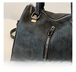 Detailed close-up of dark grey frosted leather tote bag showing metallic zipper and stitching