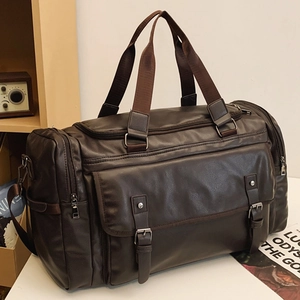Large dark brown PU leather travel bag with adjustable shoulder strap on a white table