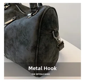 Close-up of silver metal hardware hook and stitching details on dark gray tote bag