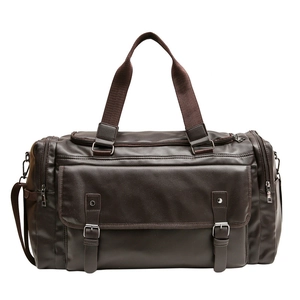 Large dark brown travel duffel bag with leather texture and multi-pocket design on white background