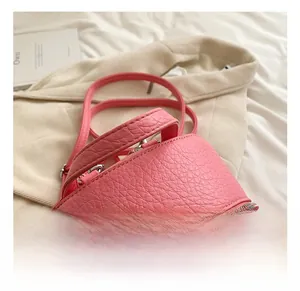 Detailed macro view of pink lychee pattern texture and dual metal zippers on backpack