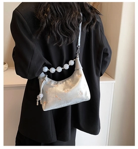 Silver-grey satin shoulder bag with delicate floral embroidery and beaded handle detail