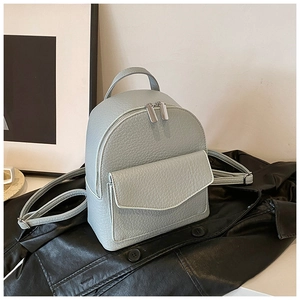Macro detail of the light green lychee textured leather mini backpack with silver zipper