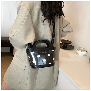 Polka dot PVC bucket bag detail with black trim and elegant MUDUO brand logo