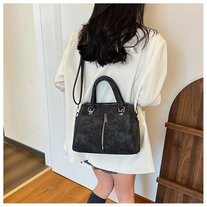 Detail of vintage tote bag featuring vertical zippers and premium soft leather texture