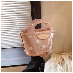 Detailed view of pink bucket bag with white polka dots and transparent PVC outer layer