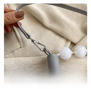 Detail of grey leather strap with silver swivel hook and white marble decorative beads