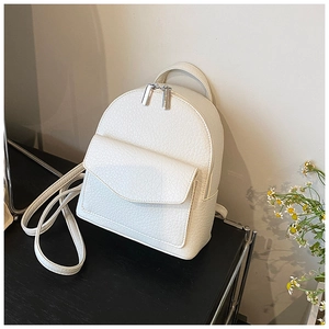 Detail of cream pleated mini backpack featuring lychee texture and silver zippers