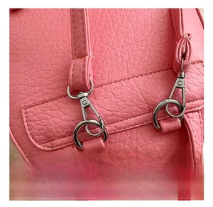 Detail of silver metal hook and stitching on the pink pebbled leather mini backpack