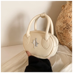Detail of a creamy white oval handbag with silver metal buckle and curved top handles