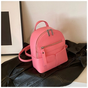 Detail of pink mini backpack with litchi grain texture and silver metal double zippers