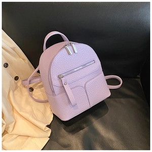 Detail of purple mini backpack with litchi texture leather and silver metal zippers