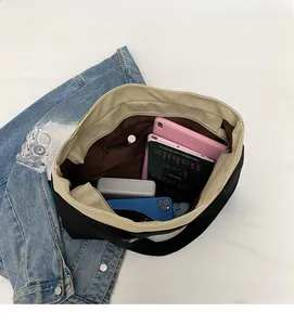 Spacious interior of canvas tote bag showing zipper pocket and daily essentials