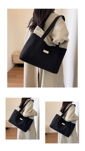 Detail shot of large contrast canvas tote bag showing the wide strap and woven texture