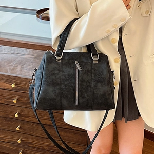 Classic black vintage leather tote bag with silver zippers and dual top handles
