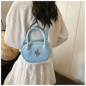 Close-up of light blue mini bag with silver artistic logo and rounded top handles