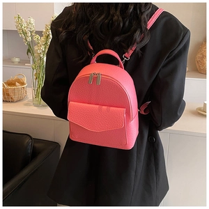 Detailed close-up of a pink pleated ballet style backpack with grainy faux leather texture