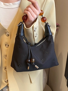 Black embroidered Boston bag with amber bead handle and floral patterns for women
