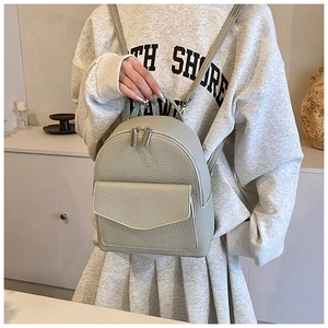 Detail of light grey-green lychee texture mini backpack with metal double zippers