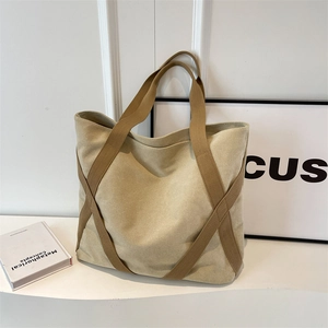 Large beige canvas tote bag with brown woven cross straps for daily commuting and students