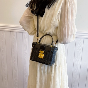 Classic black woven texture bucket bag with gold hardware worn cross-body style