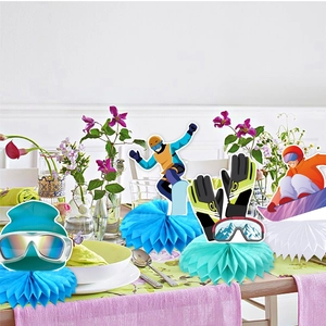 Skiing theme birthday table centerpieces with colorful honeycomb bases and winter gear cutouts