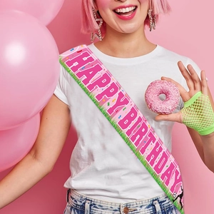 Pink satin birthday sash featuring soccer silhouettes and Happy Birthday text