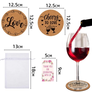 Cork coaster wedding favors set with Love and Cheers motifs, organza bag, and floral tags